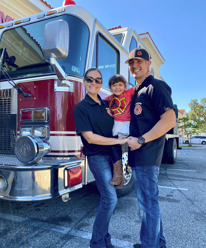 Allison and Anthony Fonseca of Station House BBQ in front of a fire truck